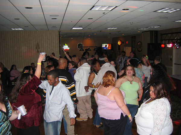 Guests dancing together at an Ample Beauties hotel party in 2006